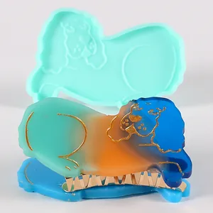 Detailed close-up showing a dog-shaped silicone mold alongside a colorful resin hair clip