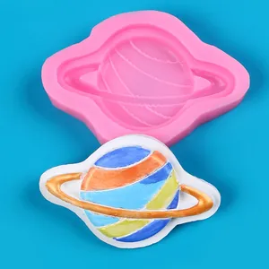 Planet-shaped silicone mold detail with colorful finished planetary cake topper.