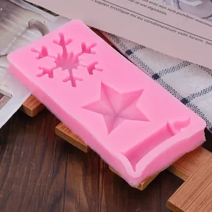 Detailed view of pink Christmas silicone mold featuring snowflake star and stocking designs