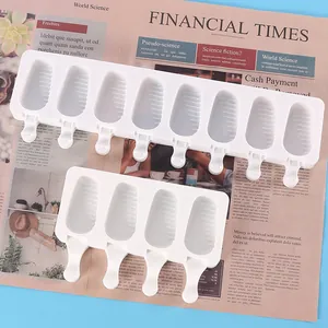 Detail view of 4 and 8 slot silicone popsicle molds on a newspaper background