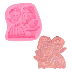 Pink silicone mold and finished plaster cast featuring a cute cartoon angel couple