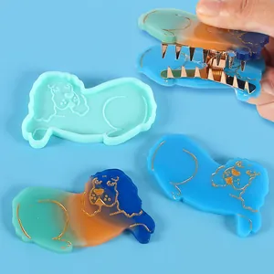 Detail view of DIY dog-shaped silicone mold with finished colorful resin hair clip accessories