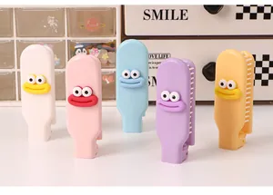 Detailed view of colorful folding mini hair combs with cute cartoon face patches.
