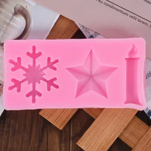 Detail view of pink Christmas silicone mold with snowflake star and candle shapes