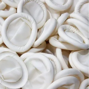 Close-up of disposable white latex powder-free finger cots for beauty and nail art protection.