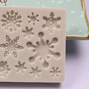 Detailed macro view of various snowflake patterns in a beige silicone fondant mold