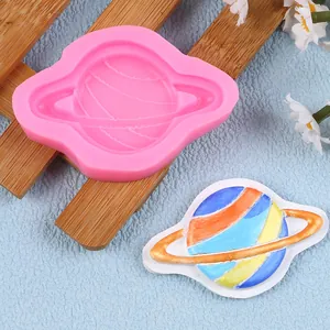 Saturn shaped pink silicone mold detail with painted planet finished product for DIY cake