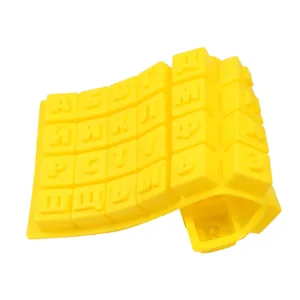 Macro detail of yellow silicone mold with embossed Russian Cyrillic alphabet letters