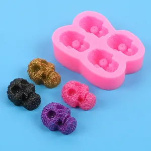 Detailed view of pink skull silicone mold with colorful DIY Halloween decorative samples
