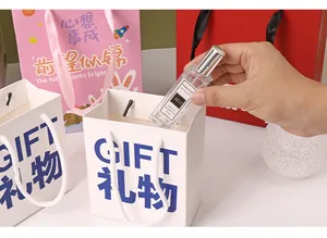 Close-up of a small cartoon gift bag being filled with a perfume bottle as a gift