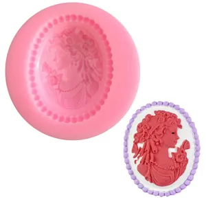 Detail view of a pink silicone mold and the finished cameo-style portrait resin relief.