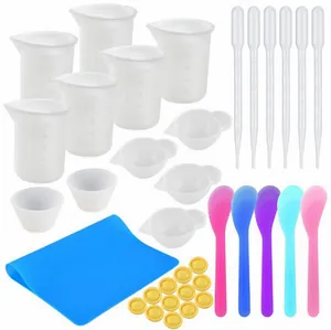 Complete DIY epoxy resin tool set with measuring cups, spoons, and mat.
