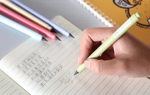 Close-up of inkless eternal pencil writing on paper with multiple color options