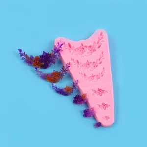 Detailed view of pink floral garland silicone mold with finished resin flower pieces