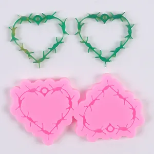 Detail of thorny heart silicone molds and green translucent resin finished pendants