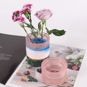 Finished DIY crystal resin storage jar with purple flowers on a lifestyle magazine