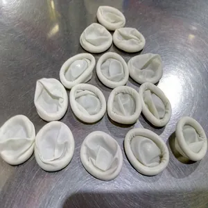Detail view of white powder-free latex finger cots for beauty and tattoo protection.