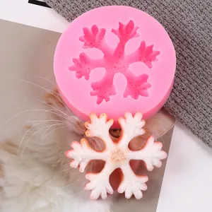 Macro detail of pink snowflake silicone mold with a finished white plaster piece