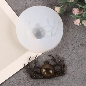 Detail of DIY Halloween spider shaped silicone mold with finished glitter resin spider object