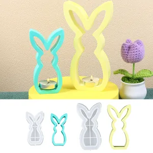 Detailed view showing rabbit silicone molds alongside finished DIY Easter candle holders