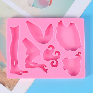 Detailed view of pink silicone mold cavities designed for DIY angel fairy figurines.