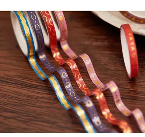 Detailed close-up showing vibrant gold foiled washi tape with elegant patterns on wood