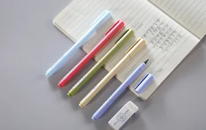 Set of pastel color everlasting pencils on notebook with eraser for art and writing