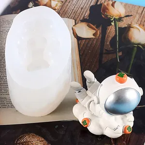 White DIY silicone astronaut mold shown alongside a finished cake topper figurine