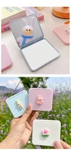 Macro view of portable mini folding mirrors featuring 3D cartoon bunny and flower charms