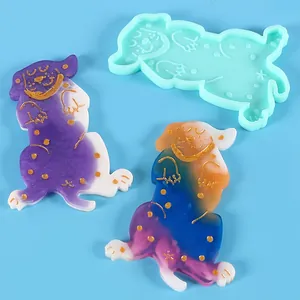 Dog shaped silicone molds and finished resin charms in vibrant purple and blue colors
