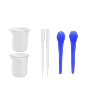 DIY epoxy resin mixing tool set with measuring cups, droppers, and blue stirring sticks