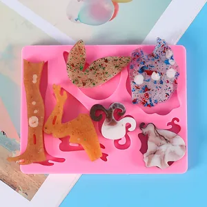 Pink silicone DIY angel and fairy mold showing various detailed finished resin craft pieces