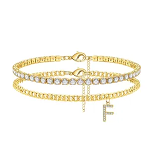 Detailed view of gold-layered anklet with cubic zirconia tennis chain and letter F charm.