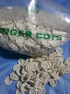 Detail view of bulk white powder-free disposable latex finger cots in transparent bag