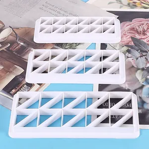 Set of 3 white plastic geometric cookie cutters with triangle patterns for DIY baking decor