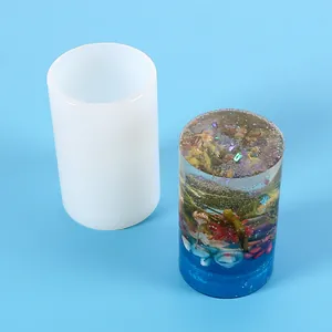 Close-up detail of cylindrical silicone mold with a finished decorative floral resin project