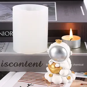 Detail view showing a white silicone astronaut mold and a finished astronaut figurine