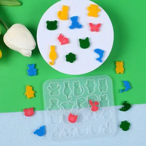 Detail of translucent silicone mold with mini animal shapes for DIY jewelry making.