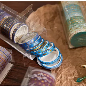 Detail view of washi tape set featuring gold foil patterns and blue color gradients.