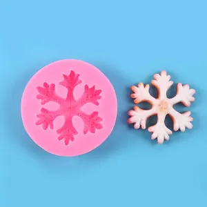 Detail view of pink snowflake silicone mold and white resin snowflake decoration