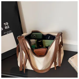Interior view showing the large capacity of the stylish cream and brown tote bag