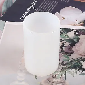 Detailed view of a white cylindrical silicone mold for DIY aromatherapy candle making.