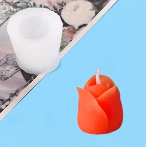 Close-up detail of tulip-shaped silicone mold and finished orange flower candle result