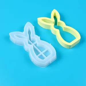 Close-up view of two rabbit-shaped silicone molds for DIY Easter candle holders.