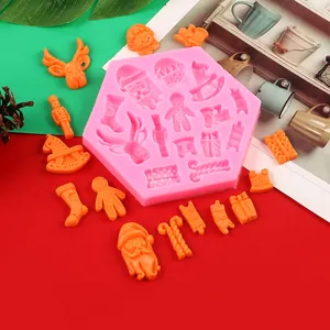 Detailed view of pink silicone Christmas mold with orange reindeer and Santa shapes.