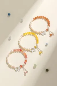 Handmade natural freshwater pearl bracelets featuring butterfly charms and colorful gemstones