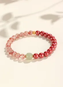 Detail of cinnabar and Hetian jade beaded bracelet with elegant natural leaf shadows