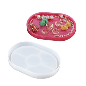 Close-up view of translucent oval silicone mold with finished pink glitter resin tray