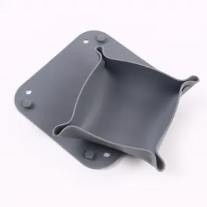 Detail view of a minimalist grey silicone desktop storage tray and non-slip coaster set