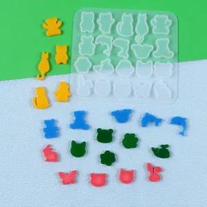 Close-up detail showing multi-shape animal silicone mold with colorful resin jewelry pieces